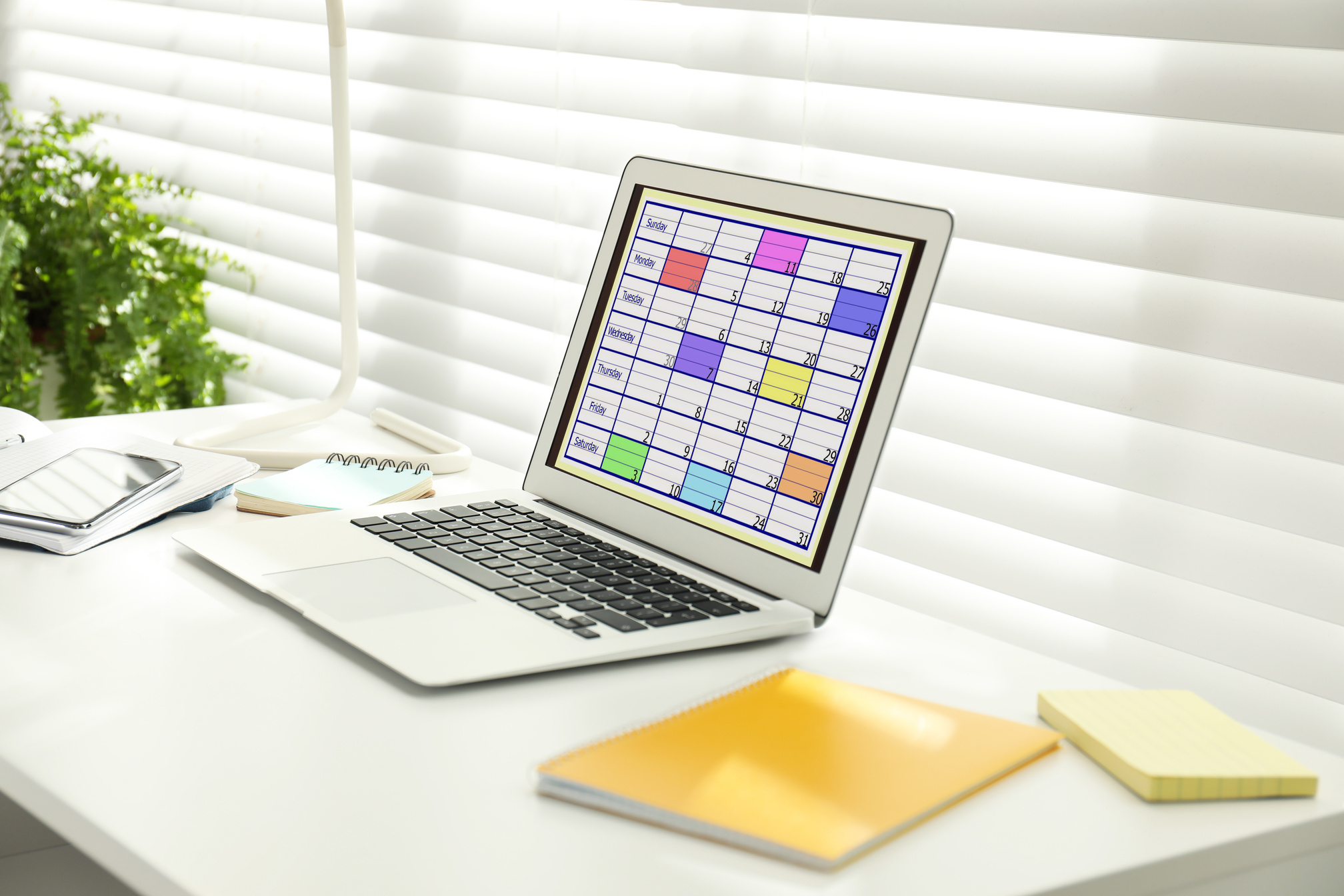 Modern Laptop with Calendar App at Table in Office